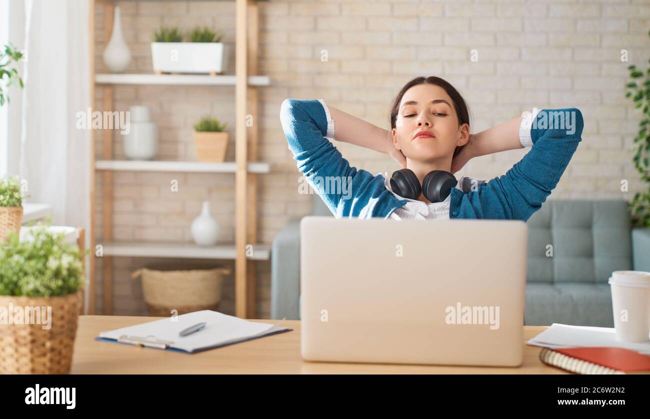 Happy casual beautiful woman working on a laptop at home Stock Photo ...
