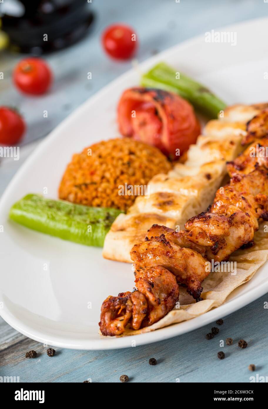 Traditional Turkish grilled Chicken shish kebab with vegetables grilled on skewers Stock Photo