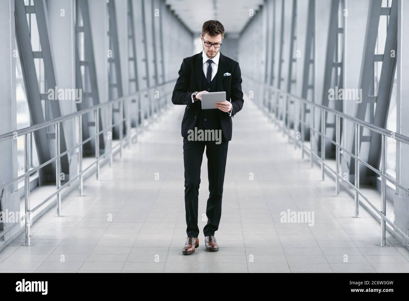 Focused urban business man holding digital tablet Stock Photo