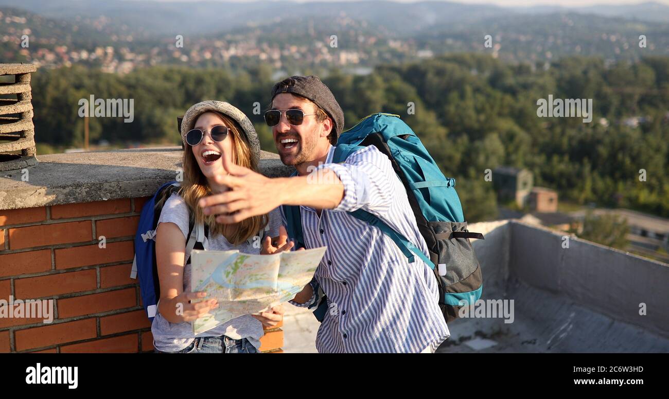 Happy young people, friends with a city map and a backpack travelling Stock Photo