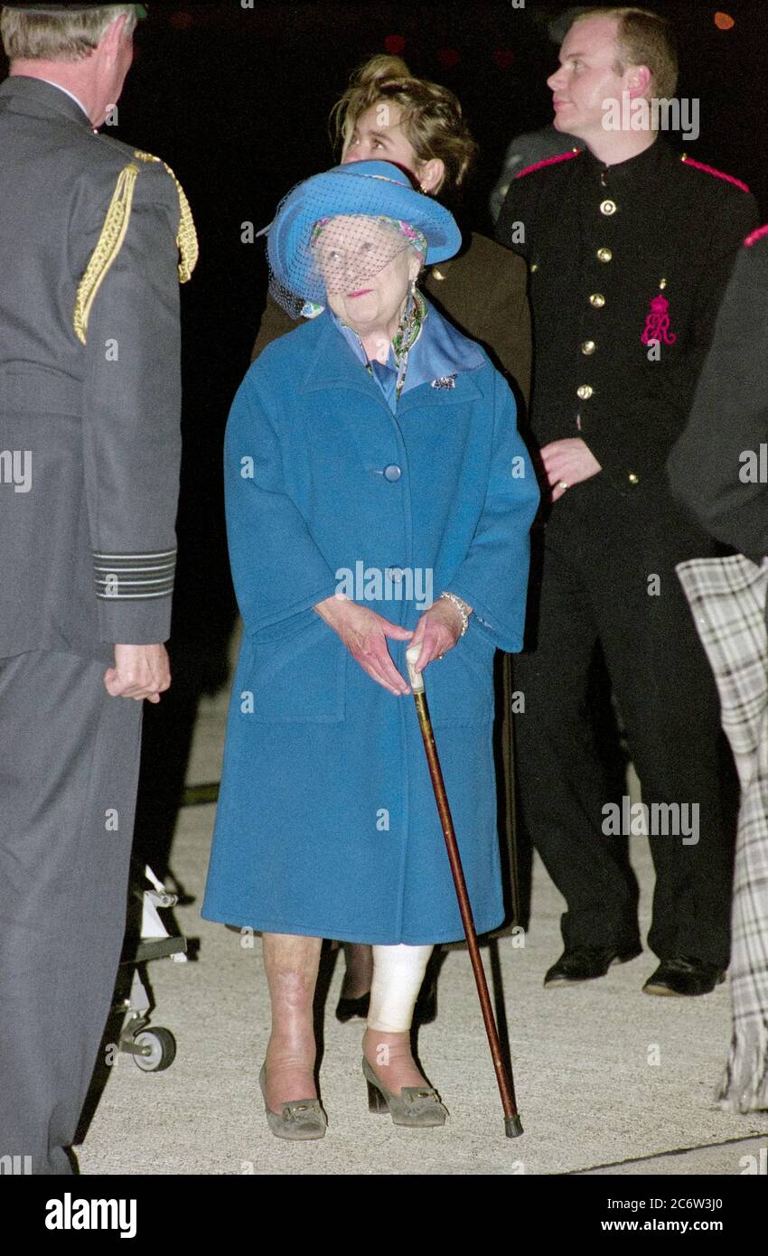 The Queen mother returns to London' Heathrow Airport with her pet