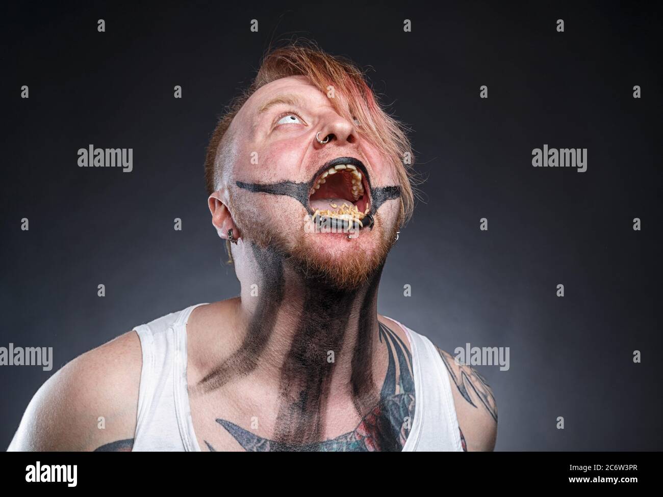 Photo of a scary mad man with maggots in his mouth Stock Photo