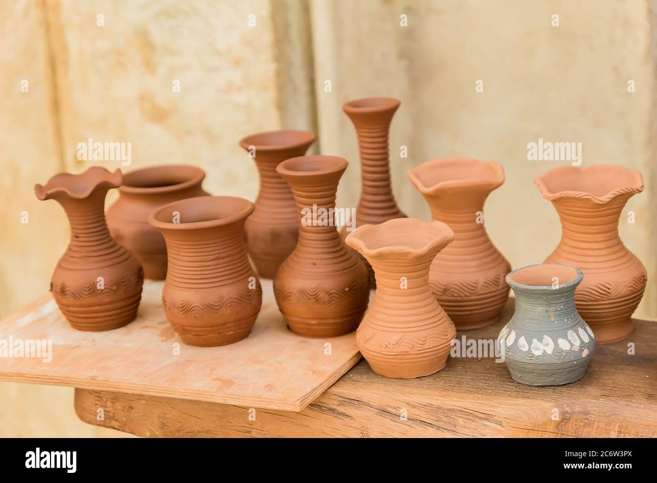 different clay pots on a wooden table Stock Photo