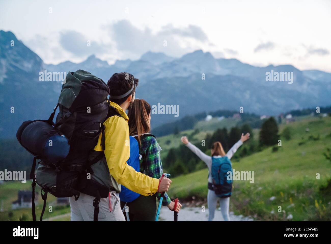 Group of happy friends with backpacks hiking together Stock Photo - Alamy