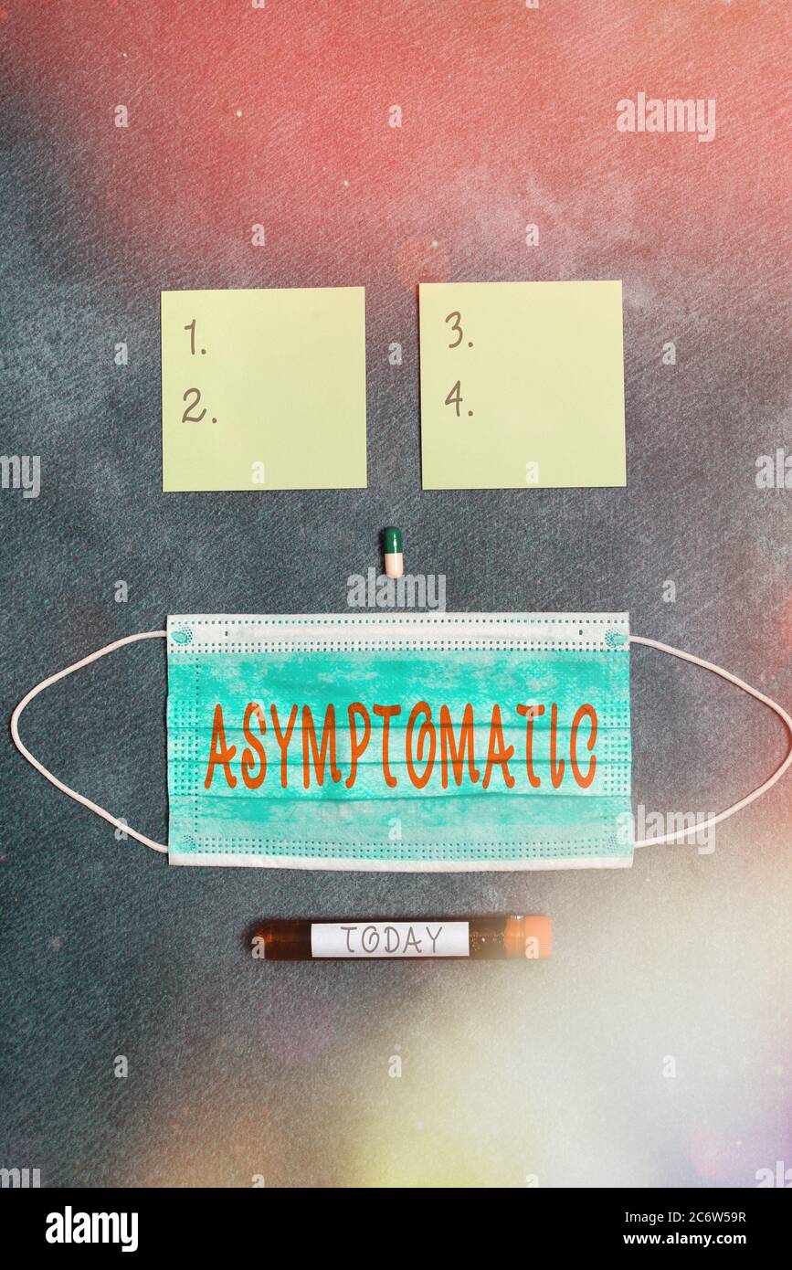 Conceptual hand writing showing Asymptomatic. Concept meaning a condition or an individual producing or showing no symptoms Set of medical equipment f Stock Photo