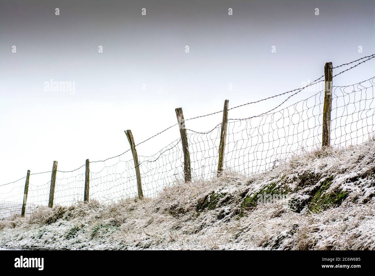 Winter fence, Puy de Dome, Auvergne, France Stock Photo