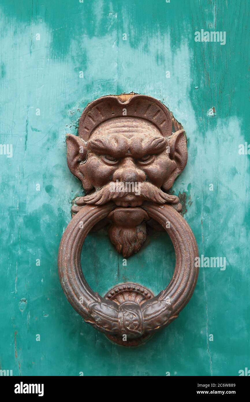 Decorative element. Vintage iron door knocker handle in the form of man