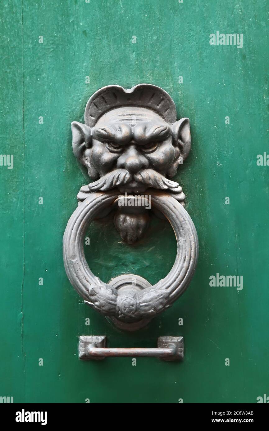 Decorative element. Vintage iron door knocker handle in the form of man