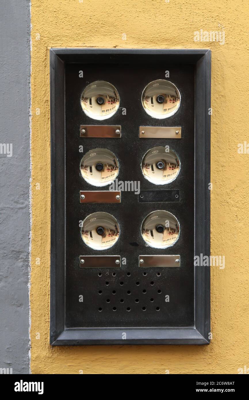 Vintage shabbylooking black metal doorbell plate with brass buttons