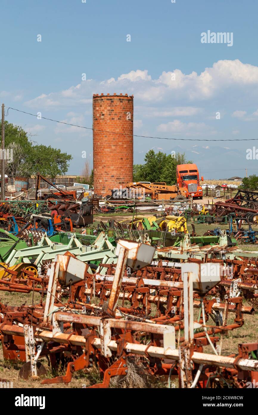 Lasalle Colorado An Old Brick Silo Stands In The Middle Of A Farm Equipment Junkyard Stock Photo Alamy