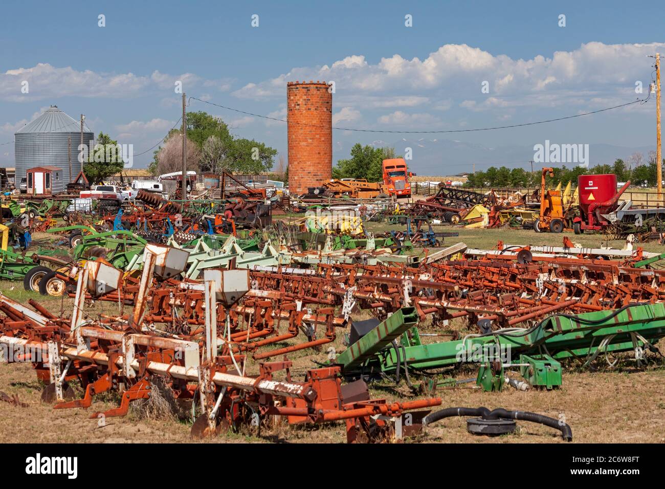 Lasalle Colorado An Old Brick Silo Stands In The Middle Of A Farm Equipment Junkyard Stock Photo Alamy