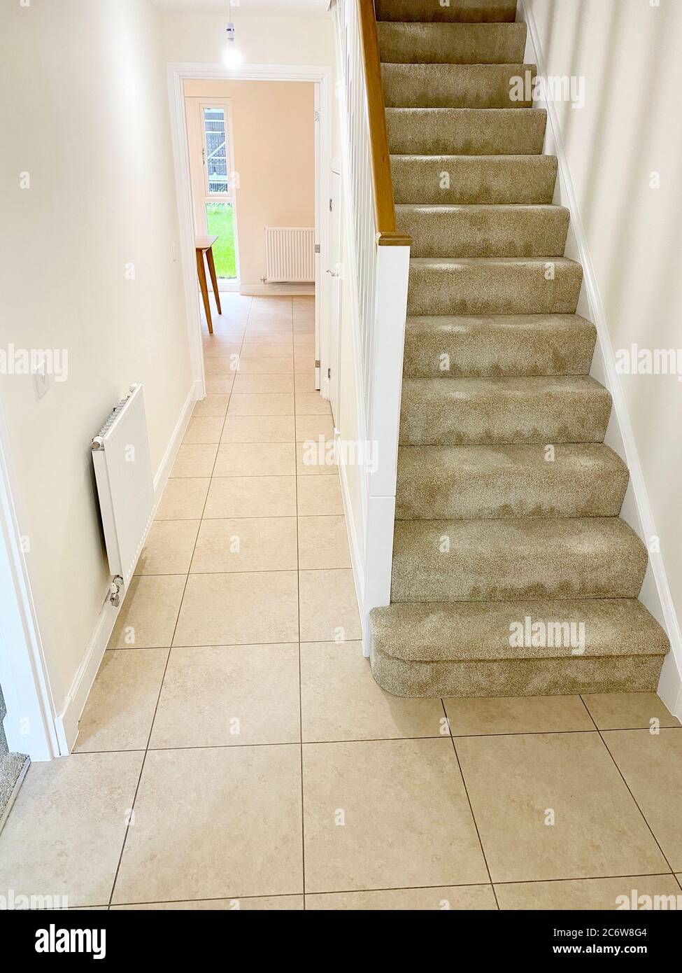 Neutral colour home interior floor tiles and staircase Stock Photo