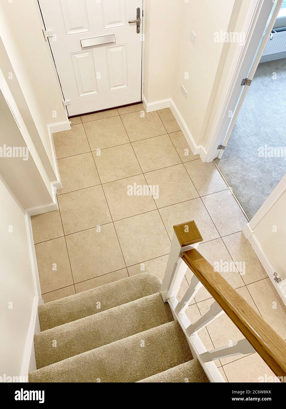 Neutral colour home interior floor tiles and staircase Stock Photo