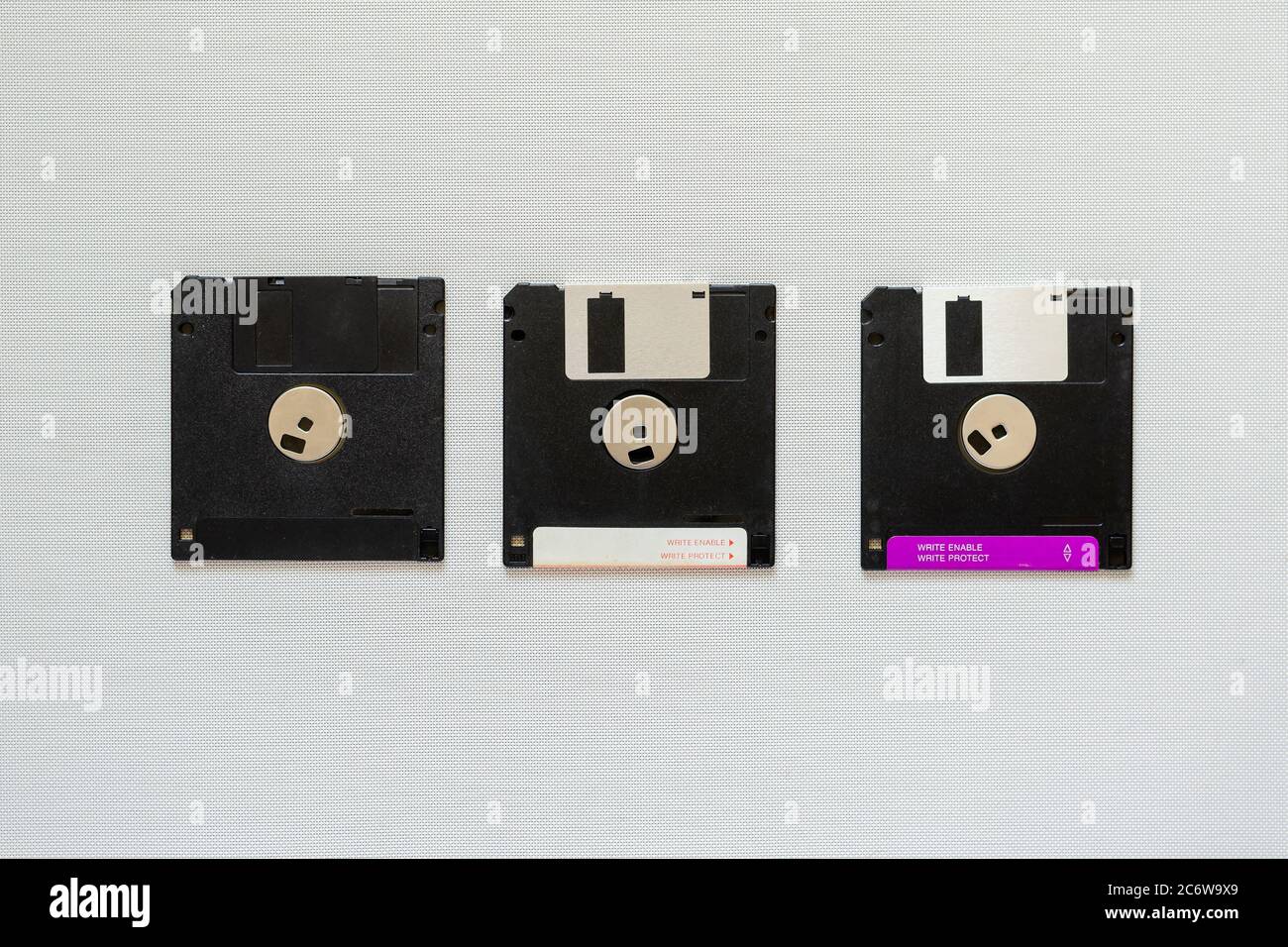 3.5 inch magnetic floppy disks. Three floppy disks on white backgrounde. Obsolete digital data storage media. Copy space Stock Photo