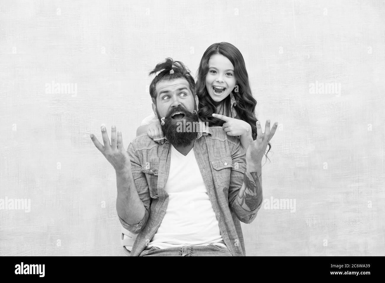 Going crazy being locked down in quarantine. Family leisure concept. Quarantine with children. Happy family. Happy childhood. Upbringing happy daughter. Daughter playing with hair. Girl dad hairdo. Stock Photo