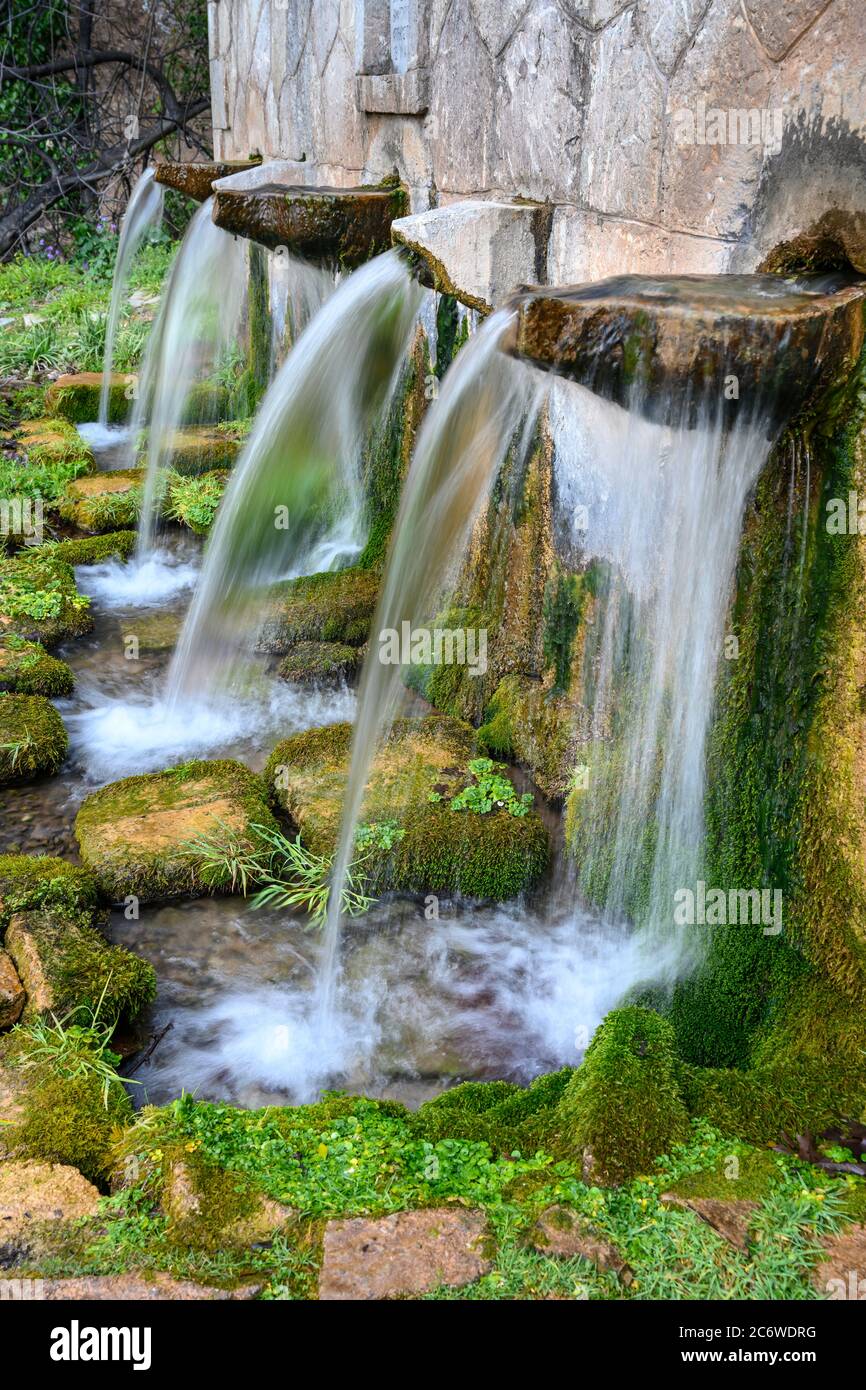 Water pouring from the  Koubes spring at the village of Kato Melpeia, North west Messinia, Peloponnese, Greece Stock Photo