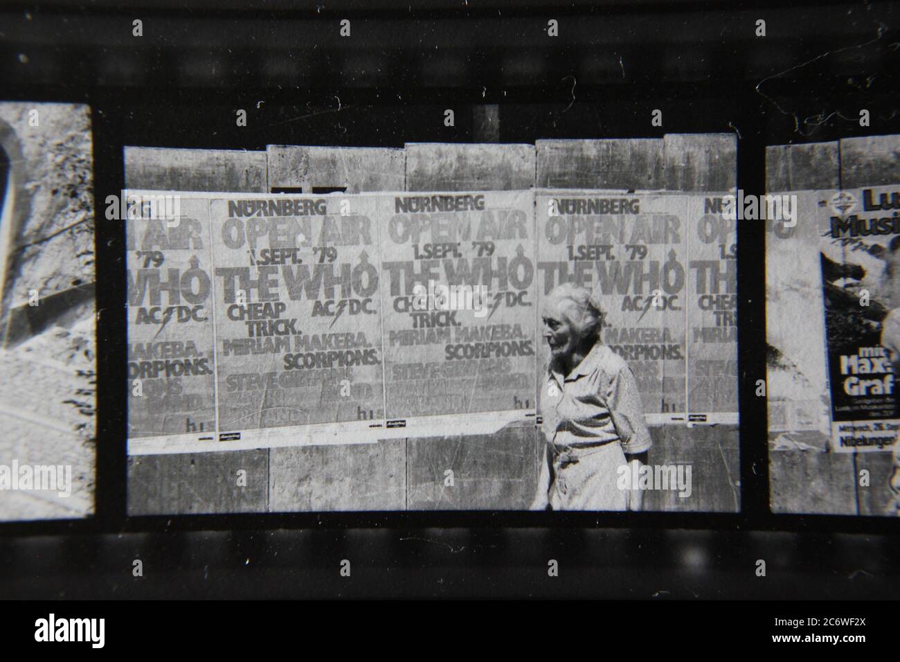 Fine 70s vintage black and white lifestyle photography of a wall of posters of upcoming events such as The Who in Nurnberg, Germany. Stock Photo