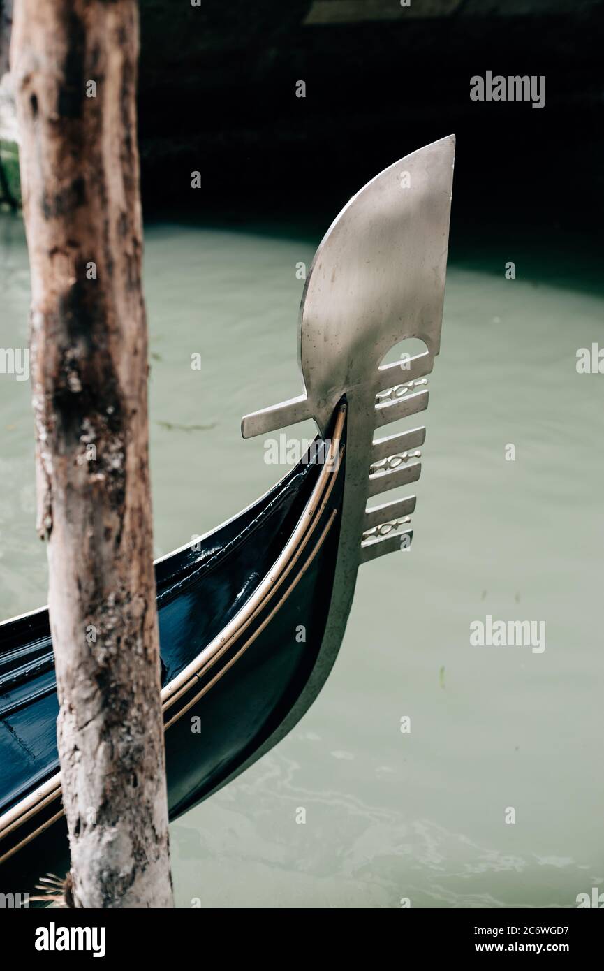 Detail of a Venetian gondola's fero da prorà (prowled; dolphin) which symbolises the city, Venice, Veneto, Italy Stock Photo