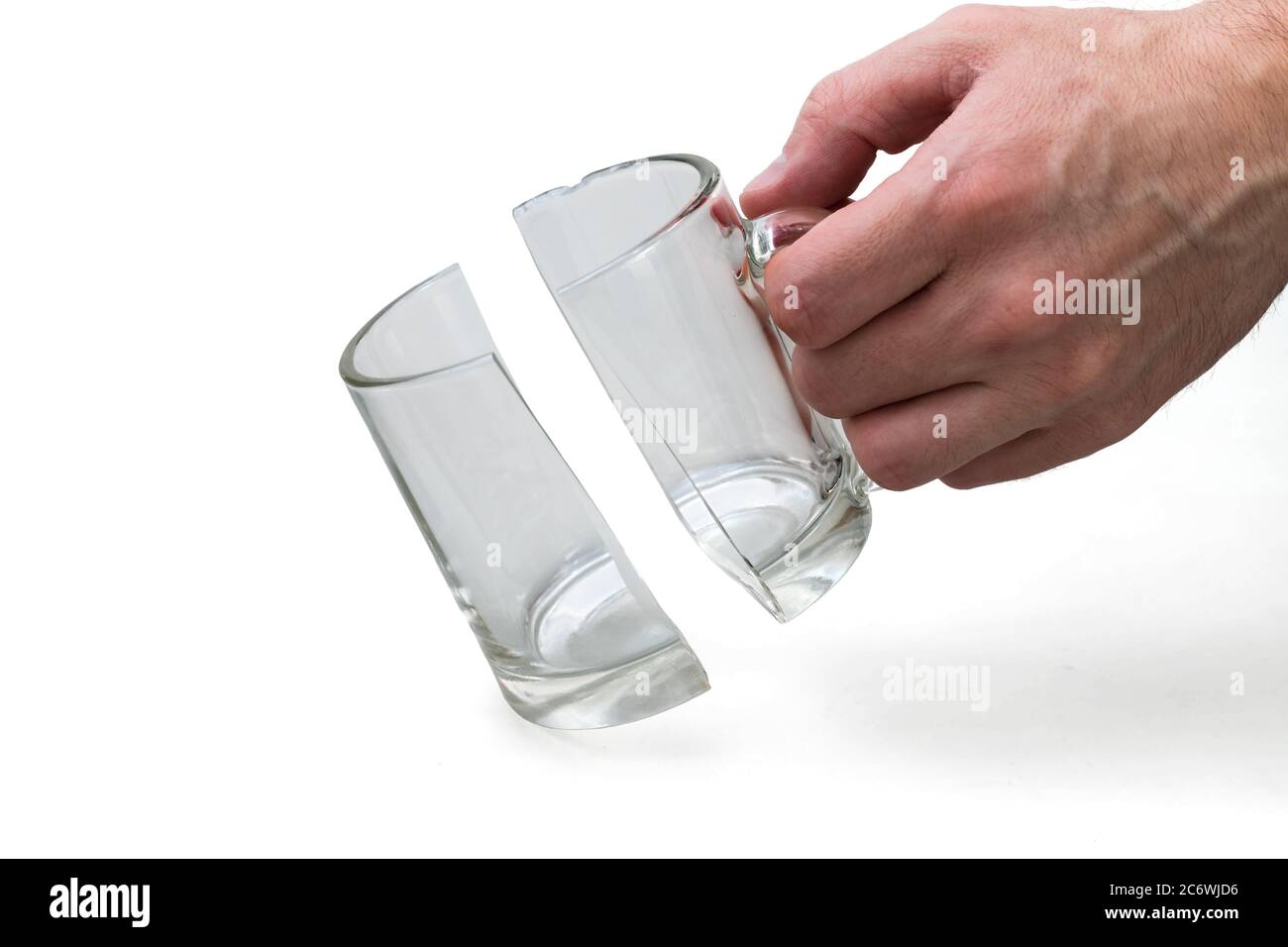 Man holds broken glass cup on white background, incident concept Stock