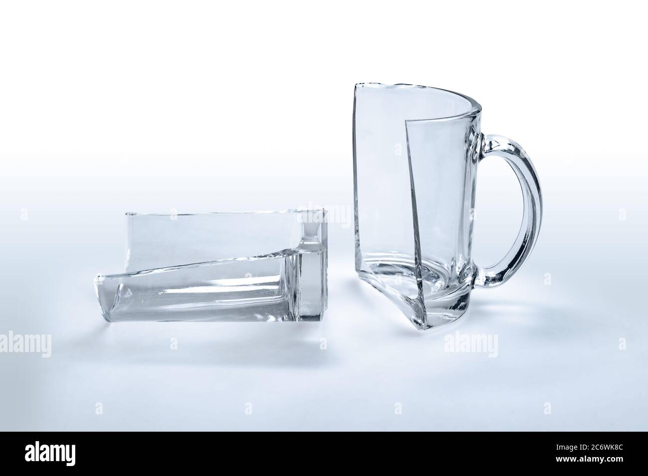 Broken glass cup on white, two halves Stock Photo Alamy
