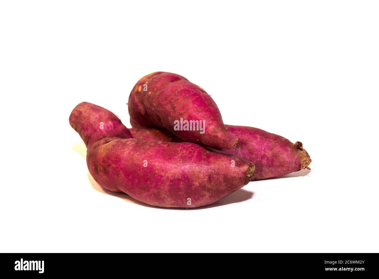 Three sweet potatoes on white background Stock Photo