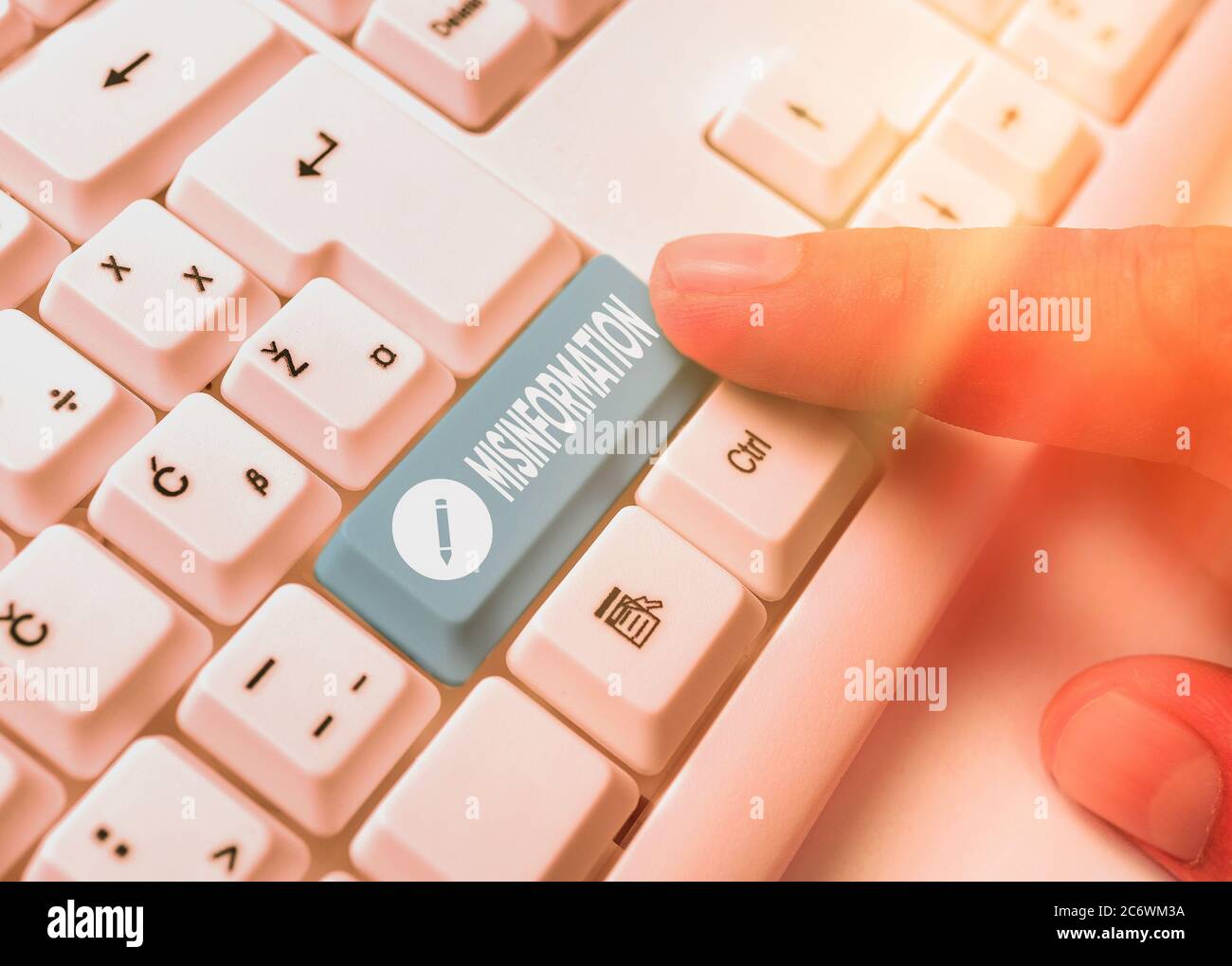 Conceptual hand writing showing Misinformation. Concept meaning false data, in particular, intended intentionally to deceive White pc keyboard with em Stock Photo