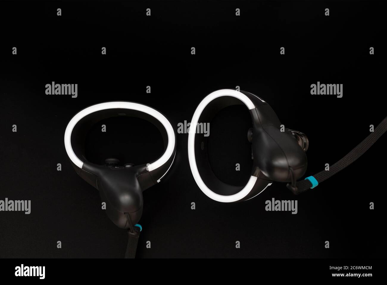 Virtual reality controllers with a led light on black background Stock Photo