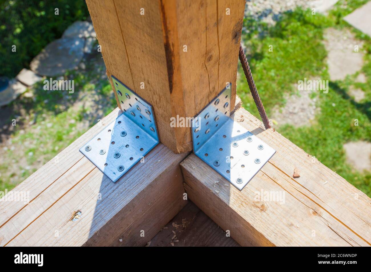Steel corner mounting plate for joining wooden structures Stock Photo