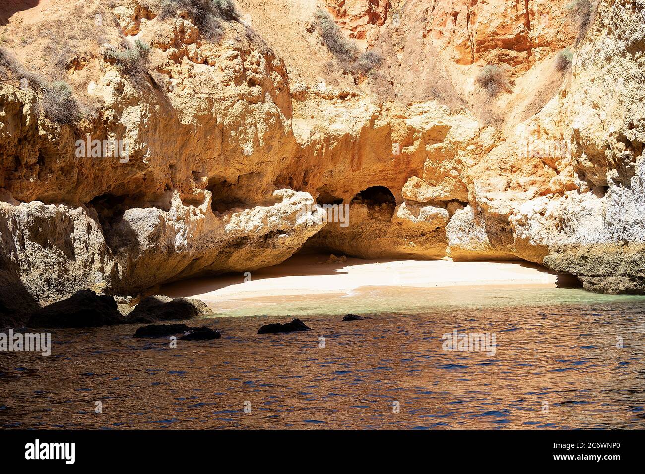 Beach hidden in a cliff cave in Carvoeiro, Algarve, Portugal Stock Photo