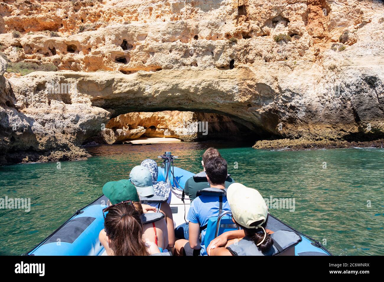 A group of tourist in a boat visiting the caves of Benagil Stock Photo