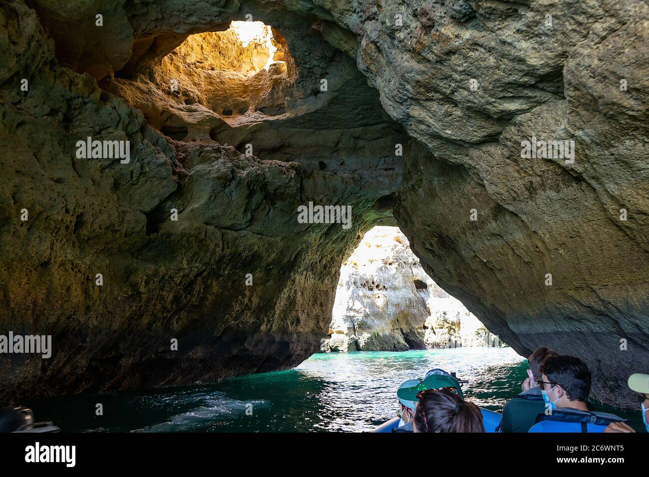 Albufeira, Portugal - July 11, 2020: A group of tourist in a boat visiting the caves of Benagil Stock Photo