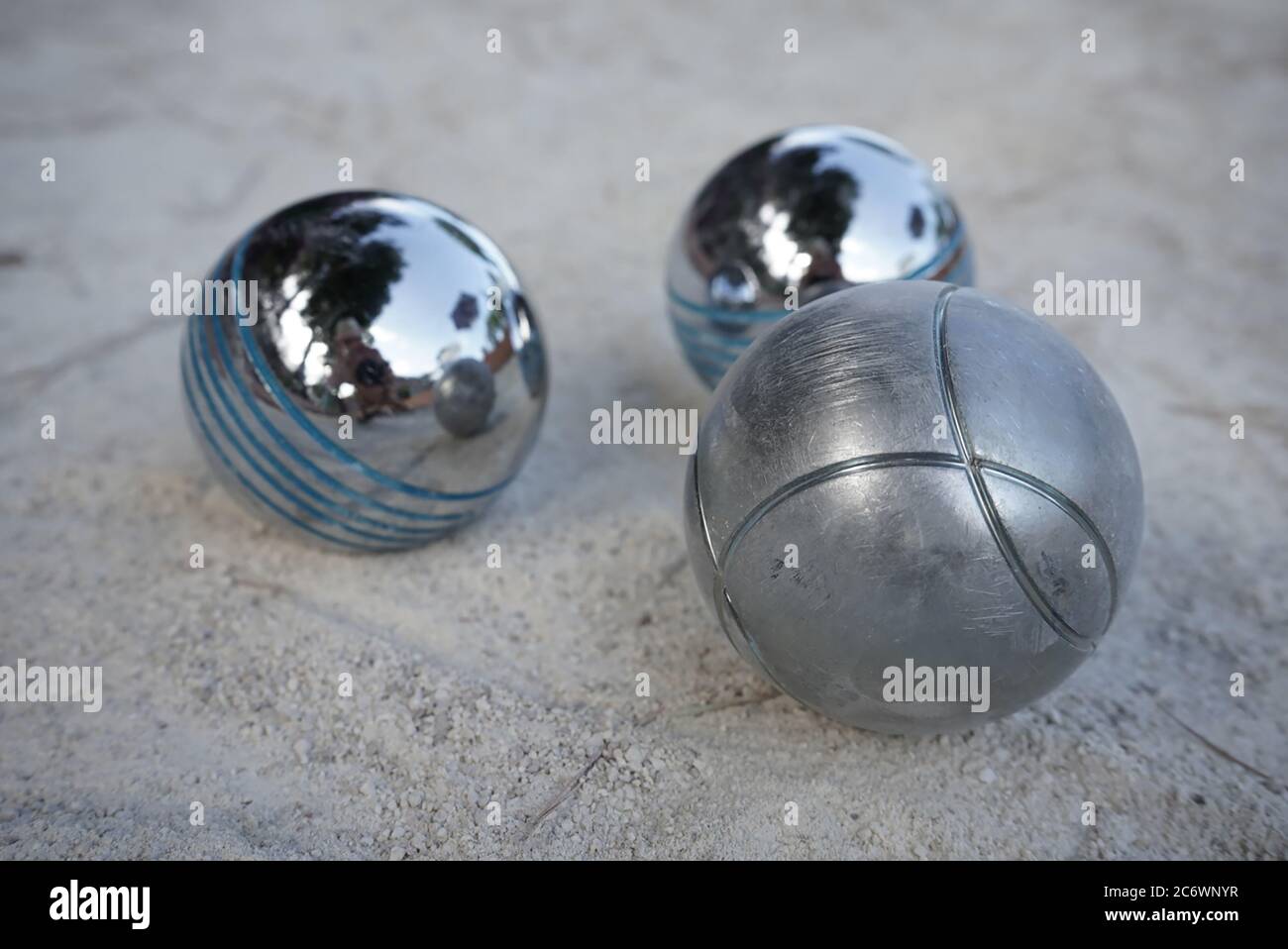 Petanque ball boules bowls on a dust floor, photo in impact. Game