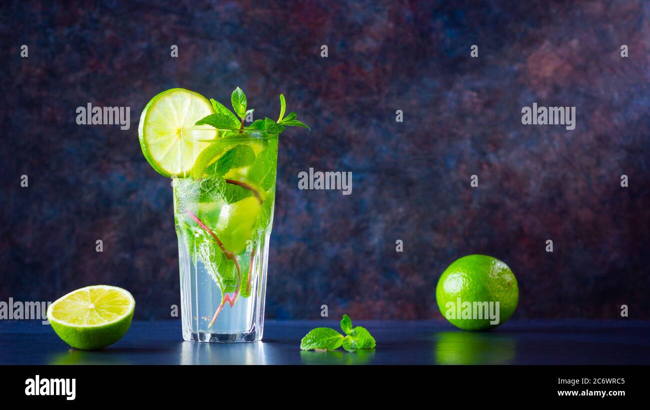Mojito cocktail with lime and mint in tall glass. Fresh mojito in glass ...