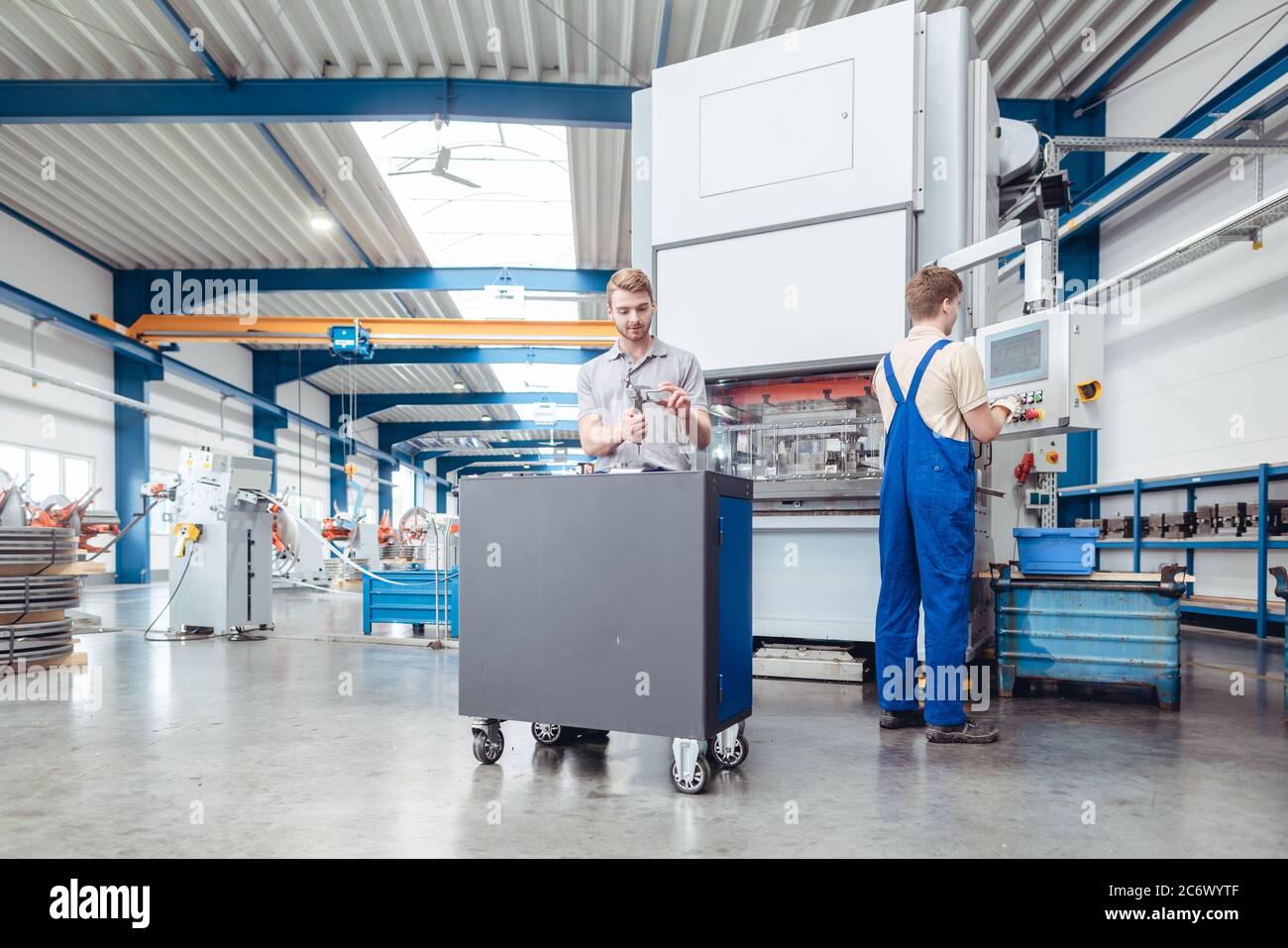 Manufacturing workers on the factory floor being industrious Stock