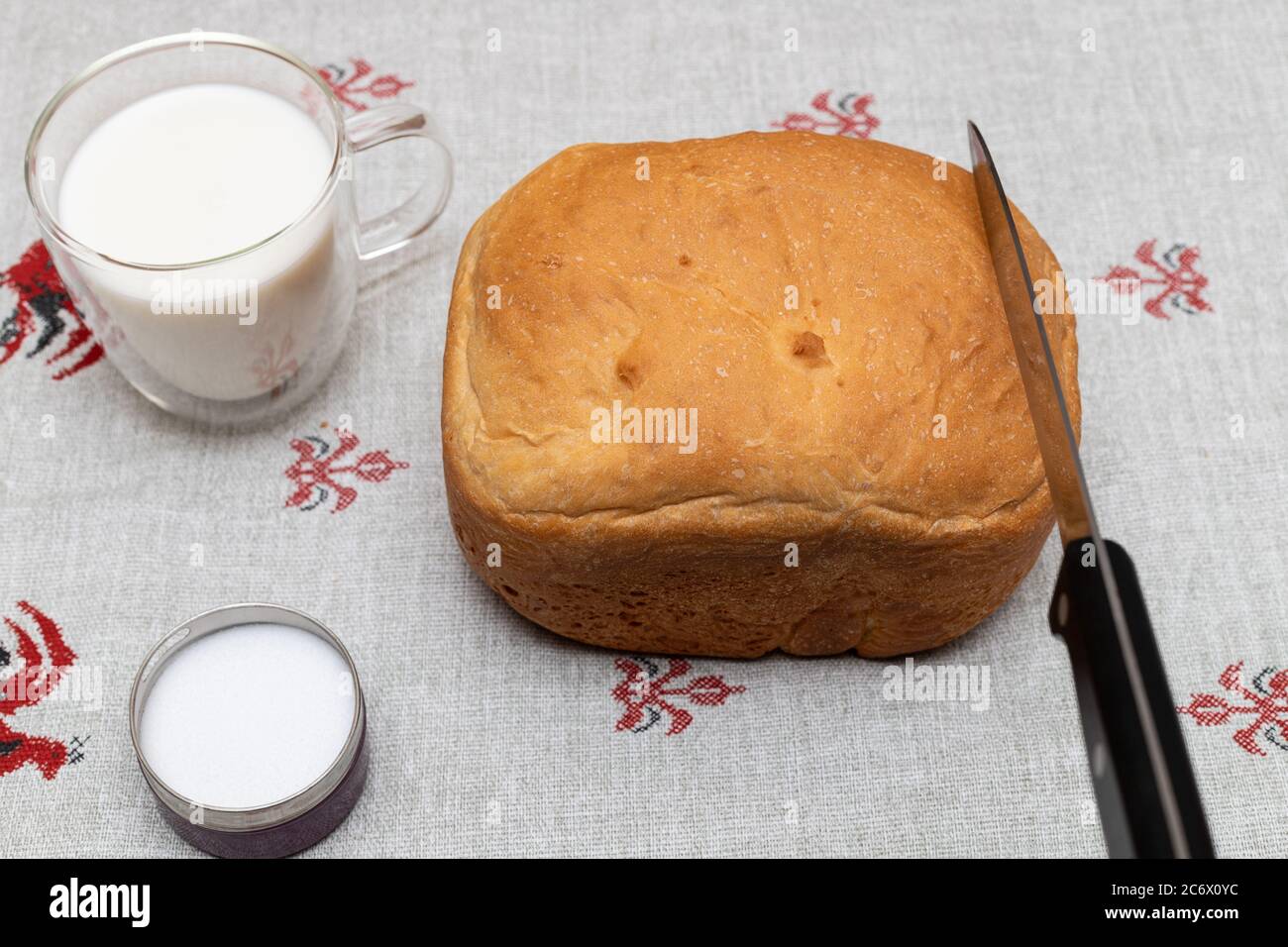 Fresh wheat bread, sald and cup of milk on a linen towel for breakfast Stock Photo