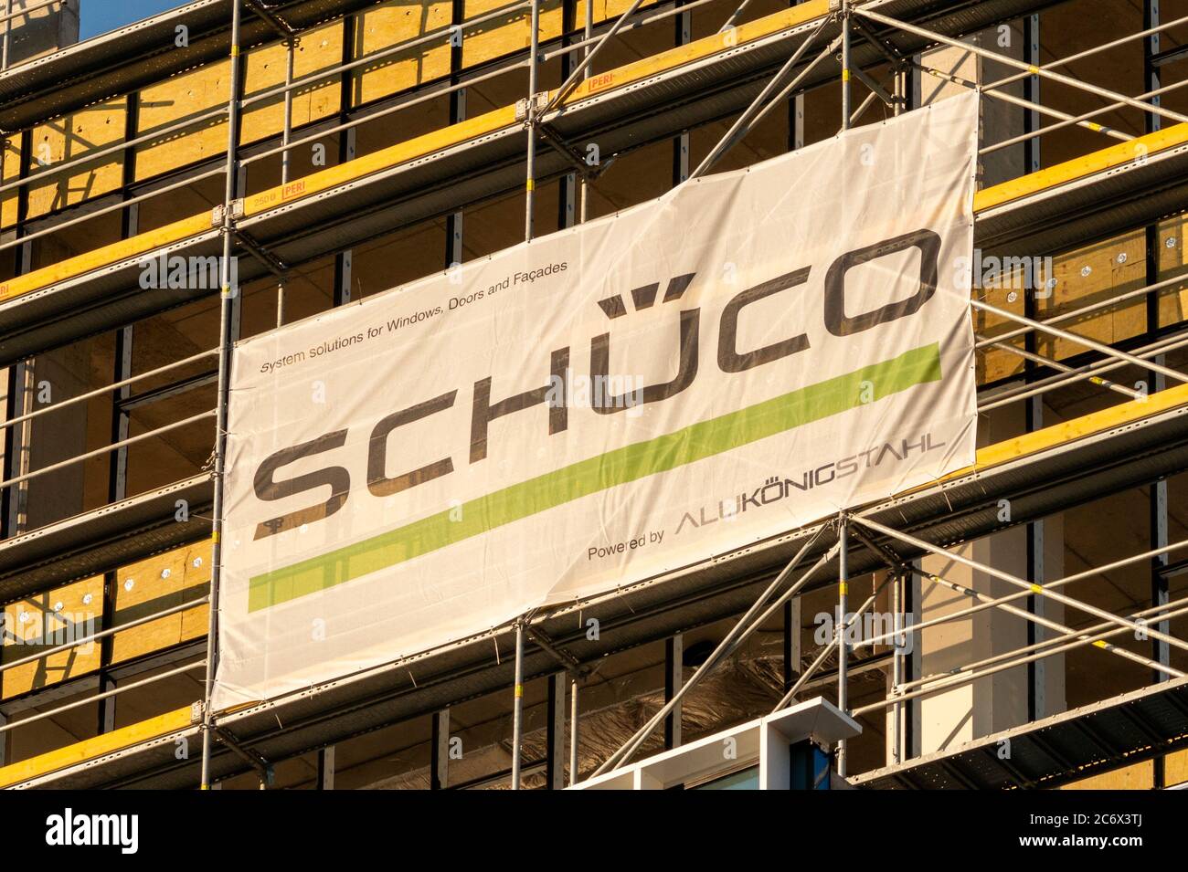 Schuco advertisement banner on construction site facade. Stock Photo