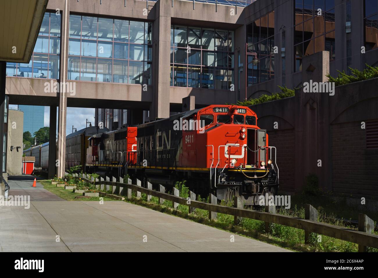 A Canadian National Railway (CNR) engines pull cars along tracks outside Alderney Gate in Dartmouth, Nova Scotia, Canada. Stock Photo