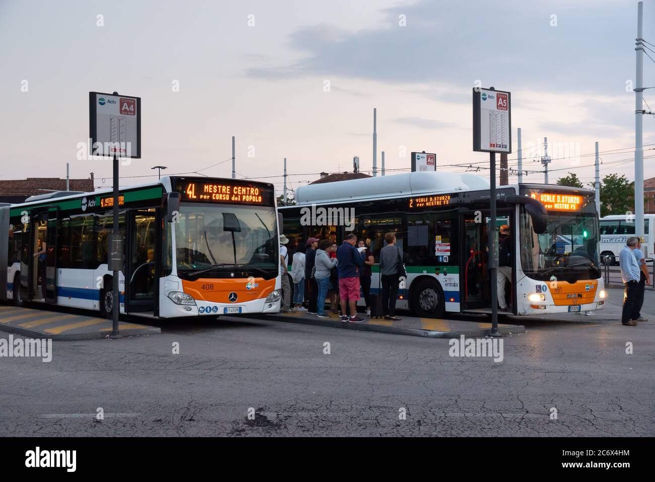 Oct. 1, 2019 - Venice, Italy: Bus station of Venice. Two line buses about to depart. People waiting at the bus stops. Stock Photo