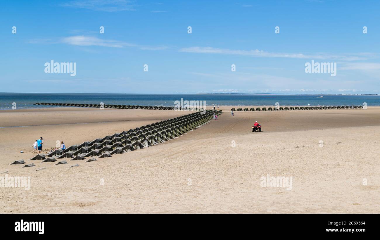 RNLI quad bike monitoring the incoming tide on Wallasey beach near Liverpool (England) in July 2020. Stock Photo
