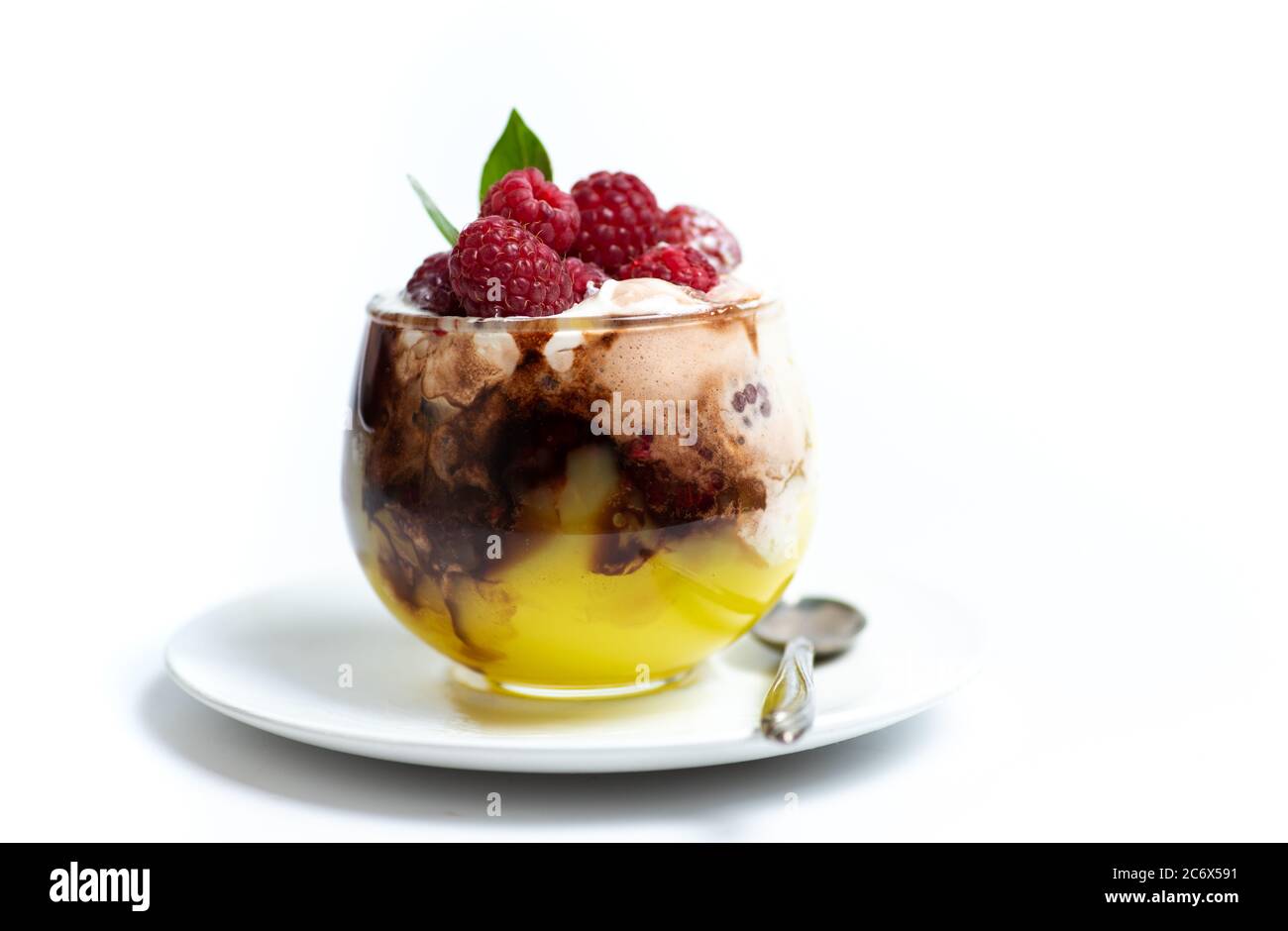 Raspberry fruit parfait in a glass cup isolated on white Stock Photo