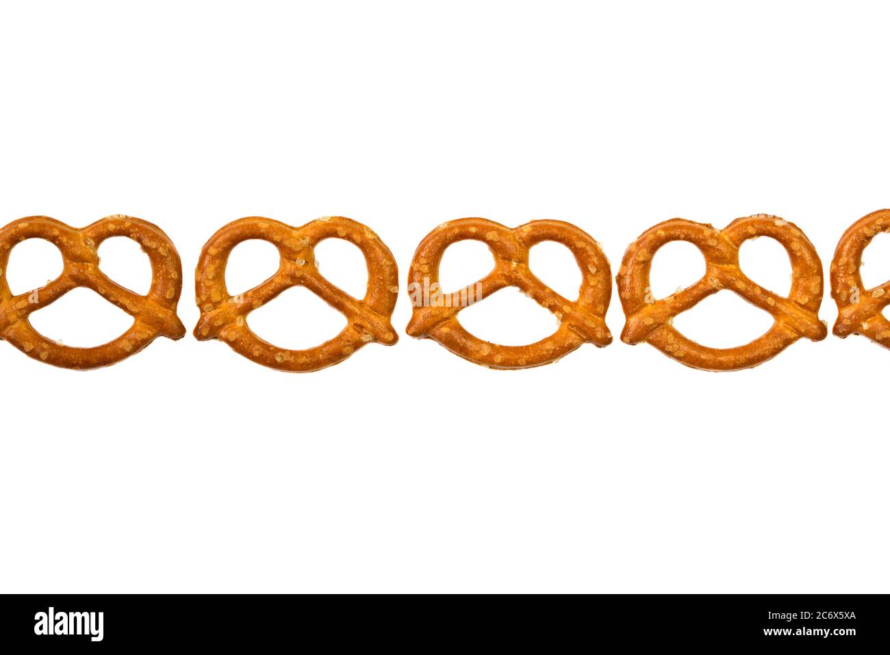 Pretzels in a row isolated on white background Stock Photo