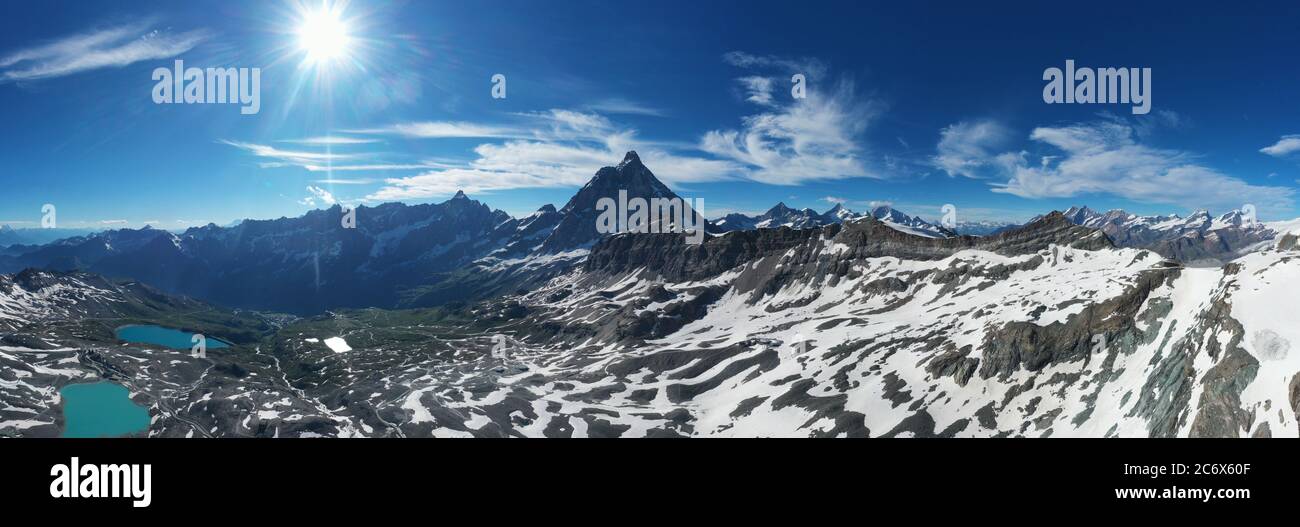 Matterhorn: Great panoramic horizontal view from above with clear blue sky, during summer sunny day - travel and lanscape on Cervino. Stock Photo