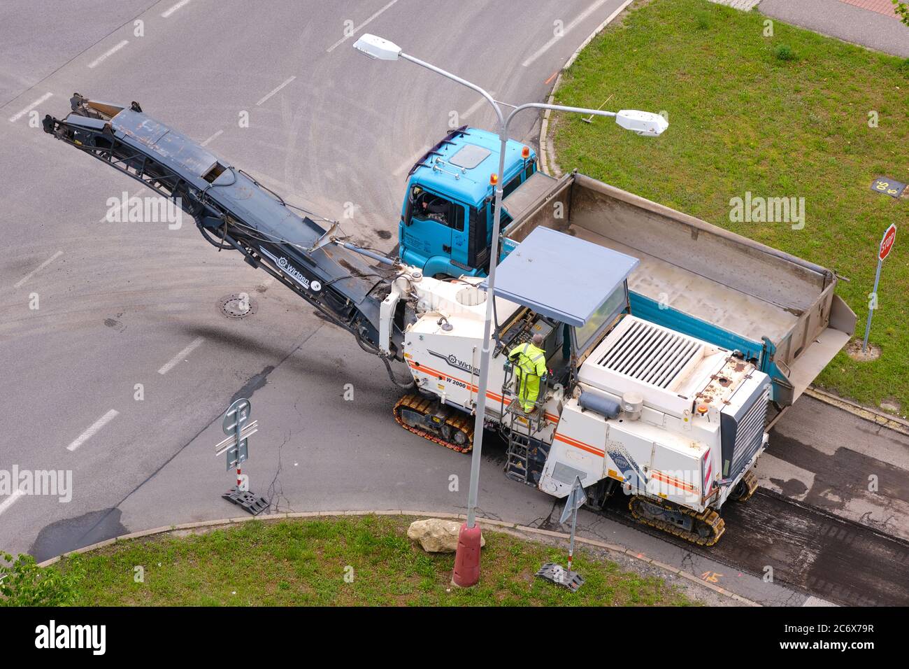 Cold milling machine removing asphalt pavement for repairing the road