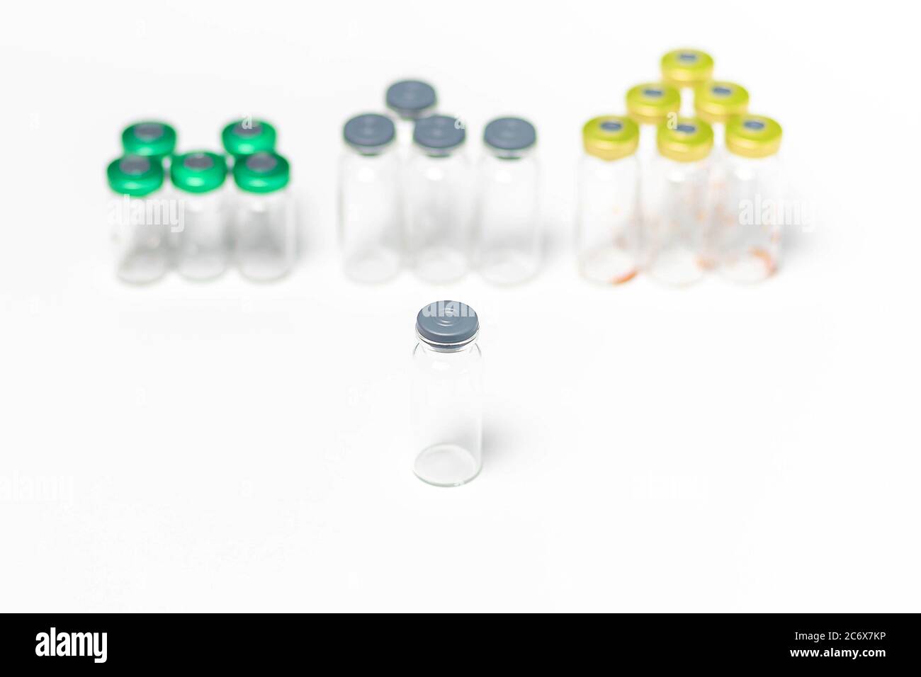 Clean, used and empty medical vials with caps isolated on white ...