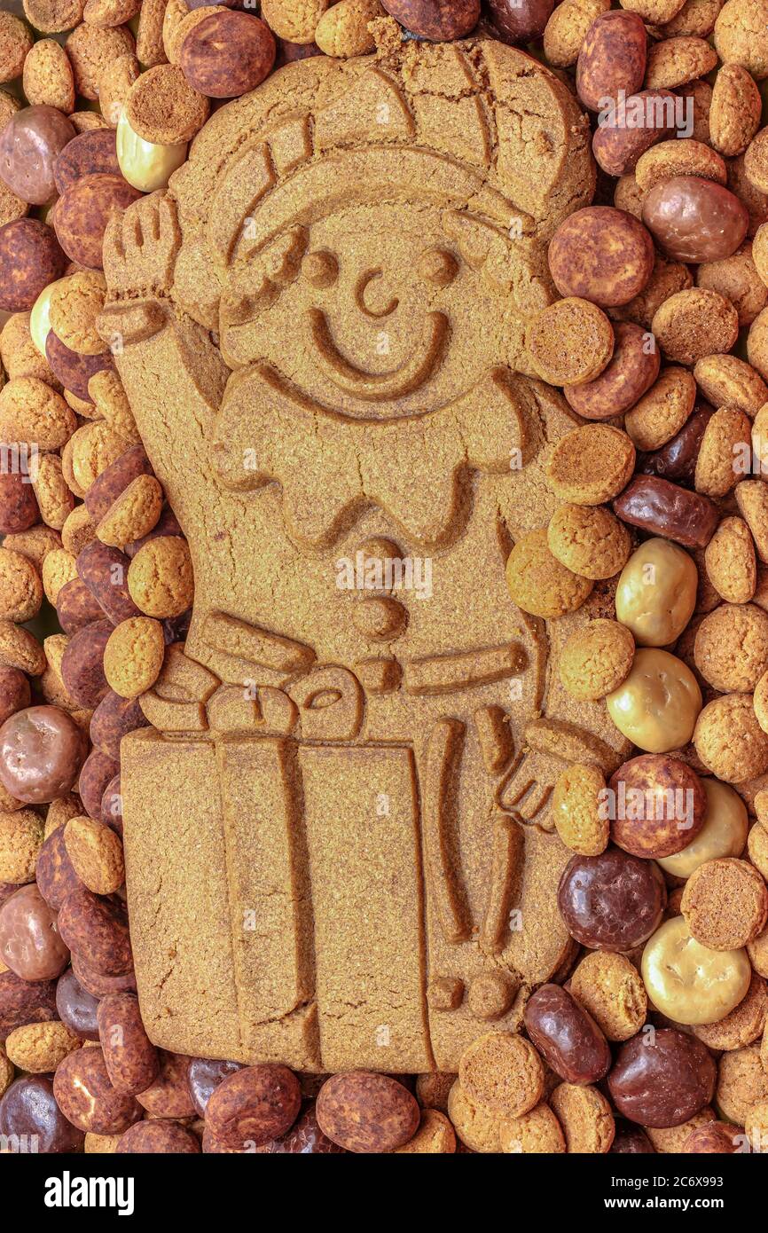 A gingerbread man on a pile of traditional sweets for the celebration of Saint Nicolas or Sinterklaas, a dutch holiday Stock Photo