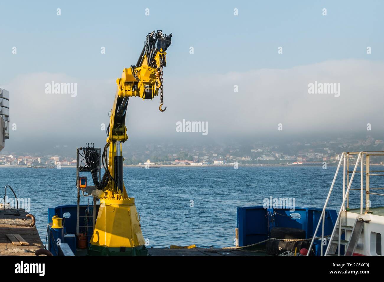 extensible crane installed on a boat outdoors Stock Photo