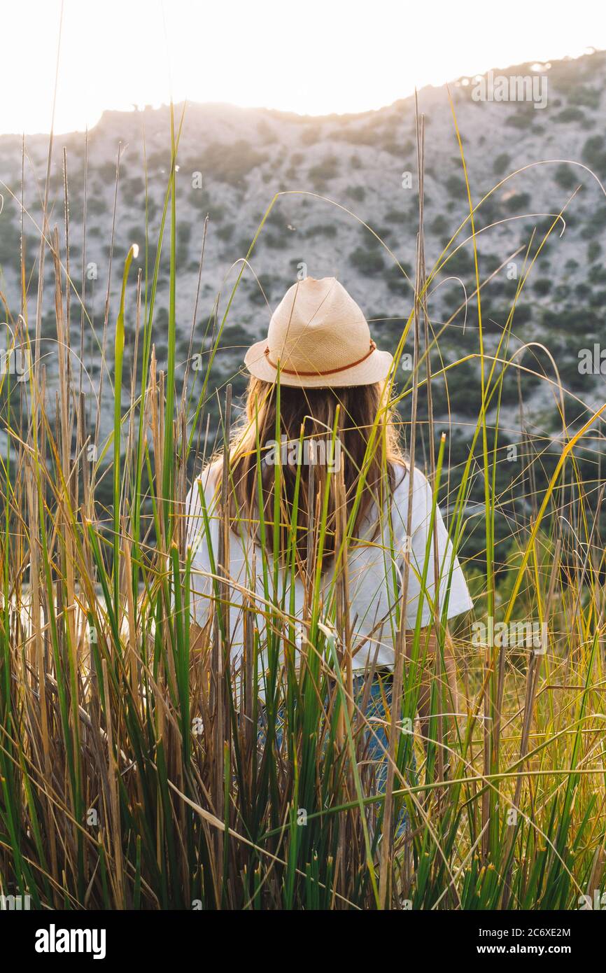 Traveling girl with a hat in the wild. Concept of freedom and going out into nature. Stock Photo