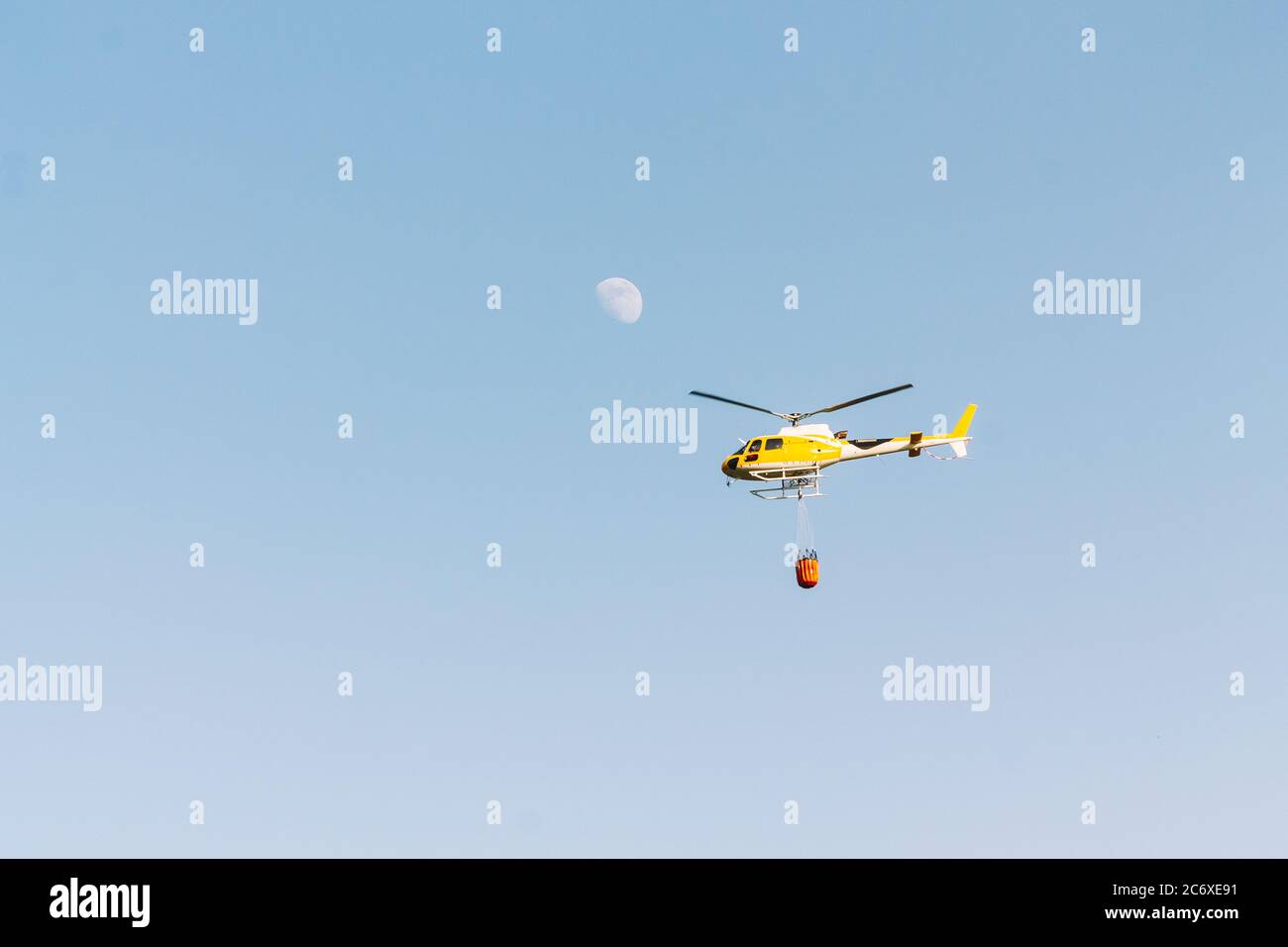 Fires flying with the moon in the mountains at sunset. Firefighter concept and extinguishing fires. Stock Photo