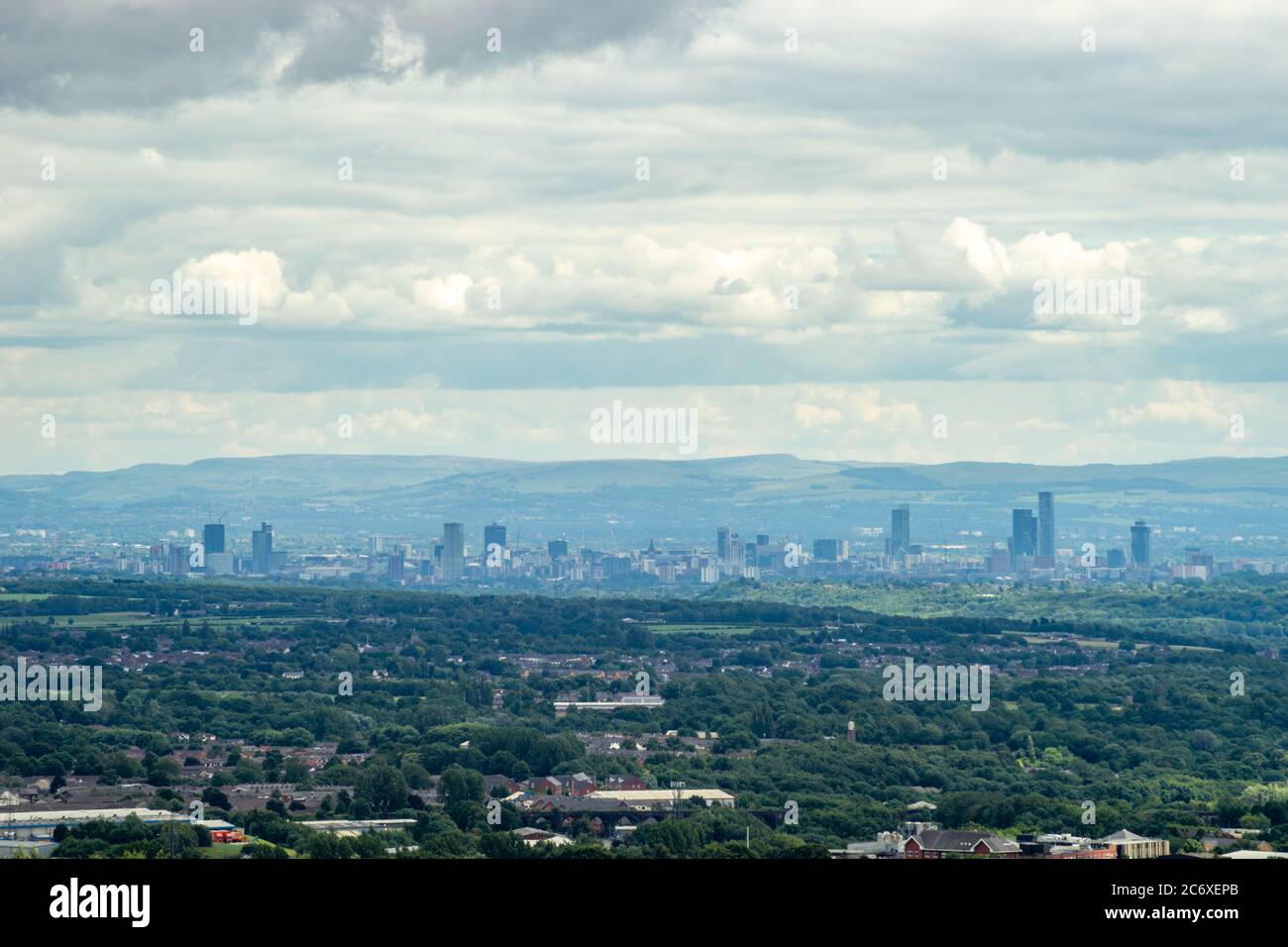 City of Manchester (England, UK) skyline seen from Horwich, Lancashire with suburbs in the foreground. Also known as cottonopolis, warehouse city Stock Photo