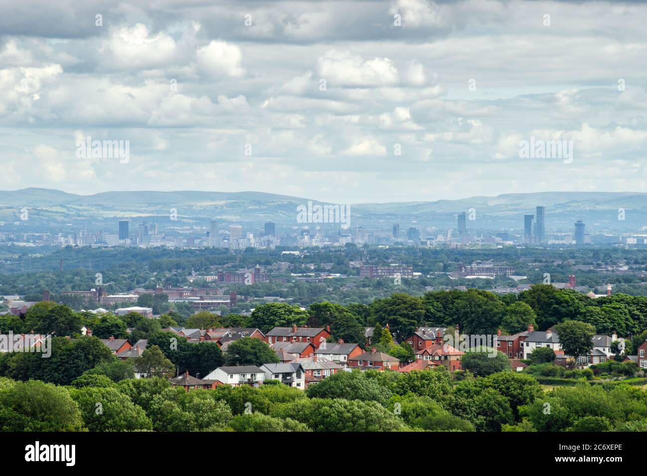 City of Manchester (England, UK) skyline seen from Horwich, Lancashire with suburbs in the foreground. Also known as cottonopolis, warehouse city Stock Photo